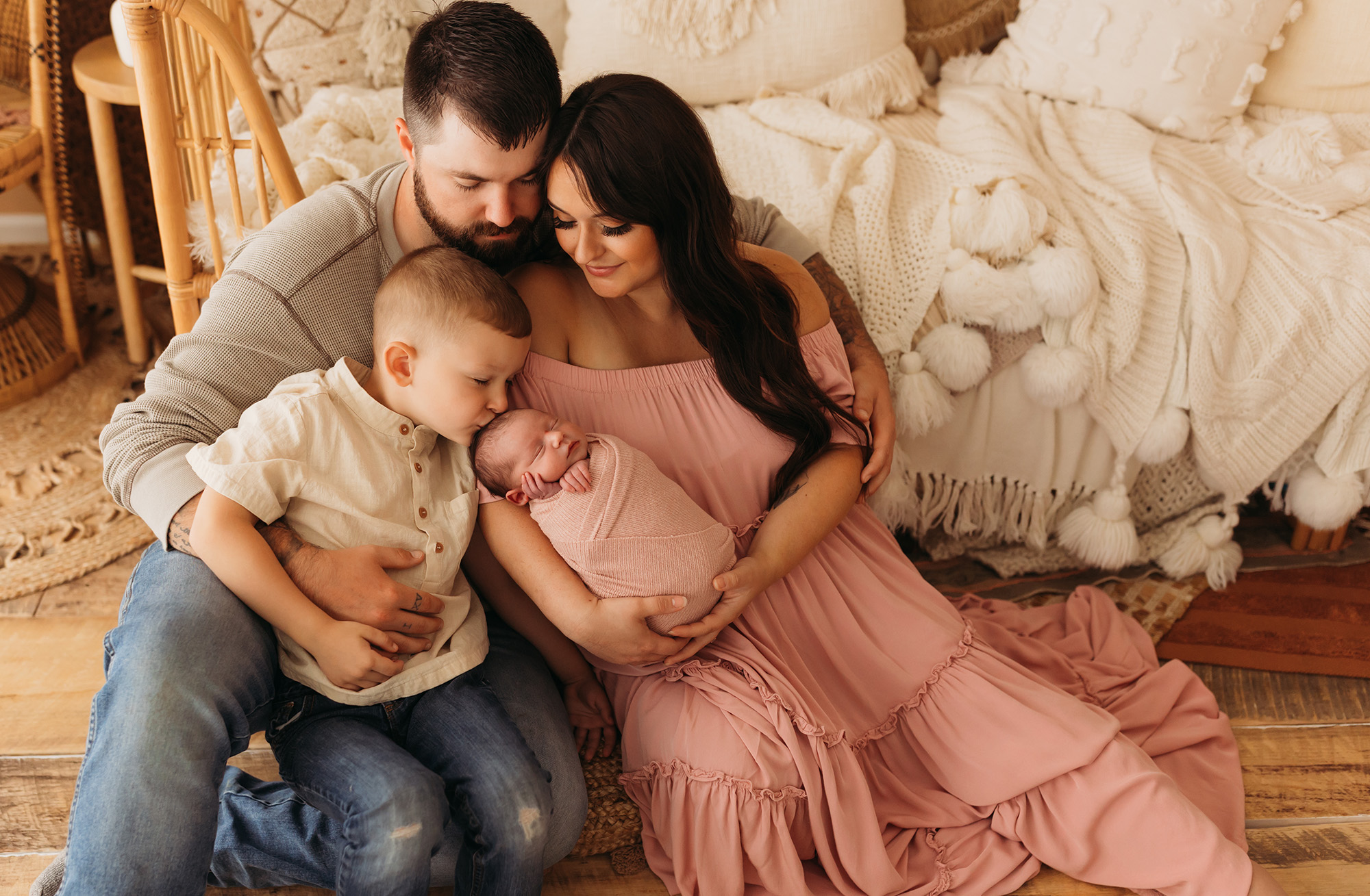 family newborn photos with brother kissing baby's head